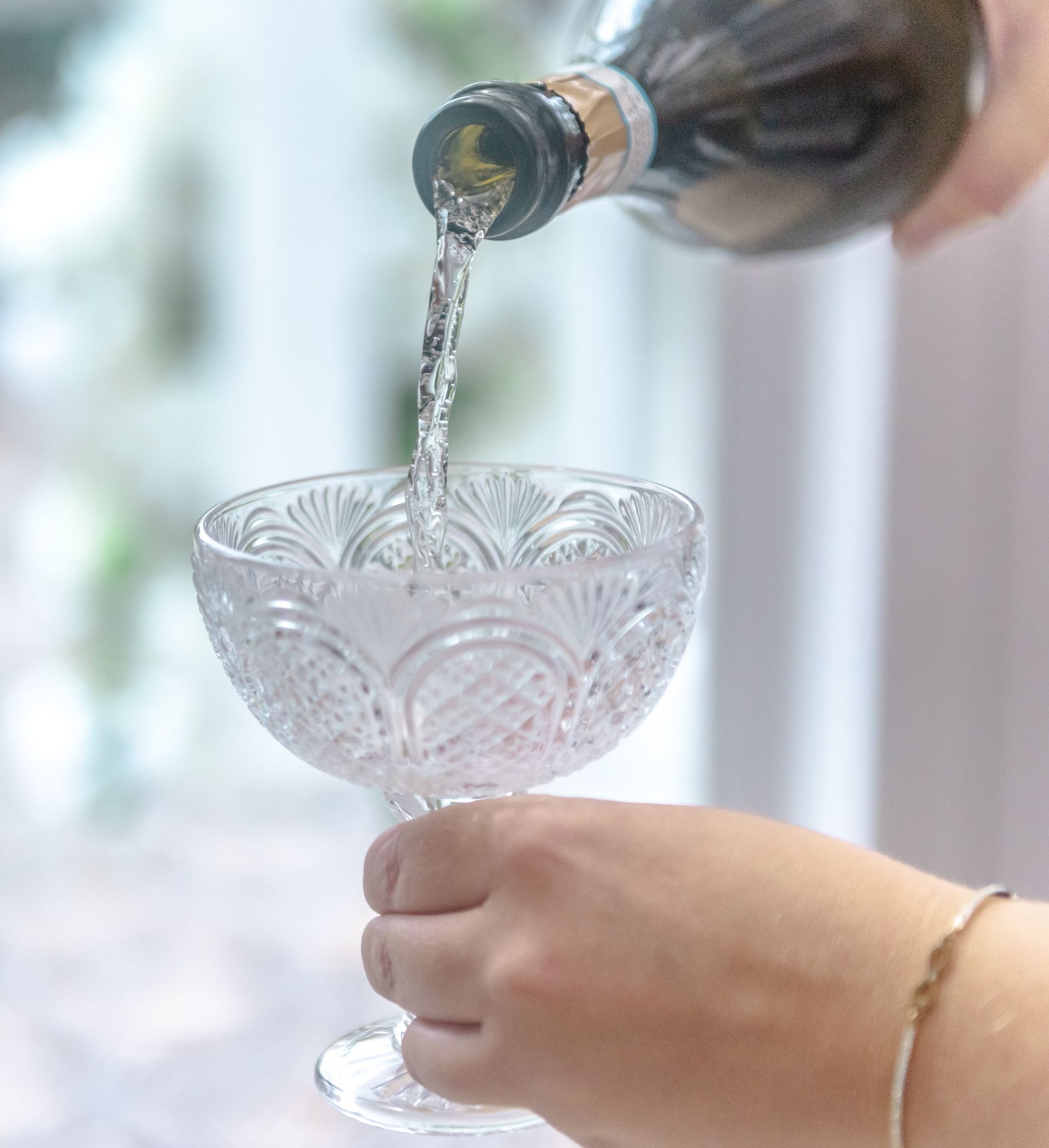 Woman Pouring Champagne into a Glass Closeup-min.jpg Woman Pouring Champagne into a Glass Closeup-min.jpg
